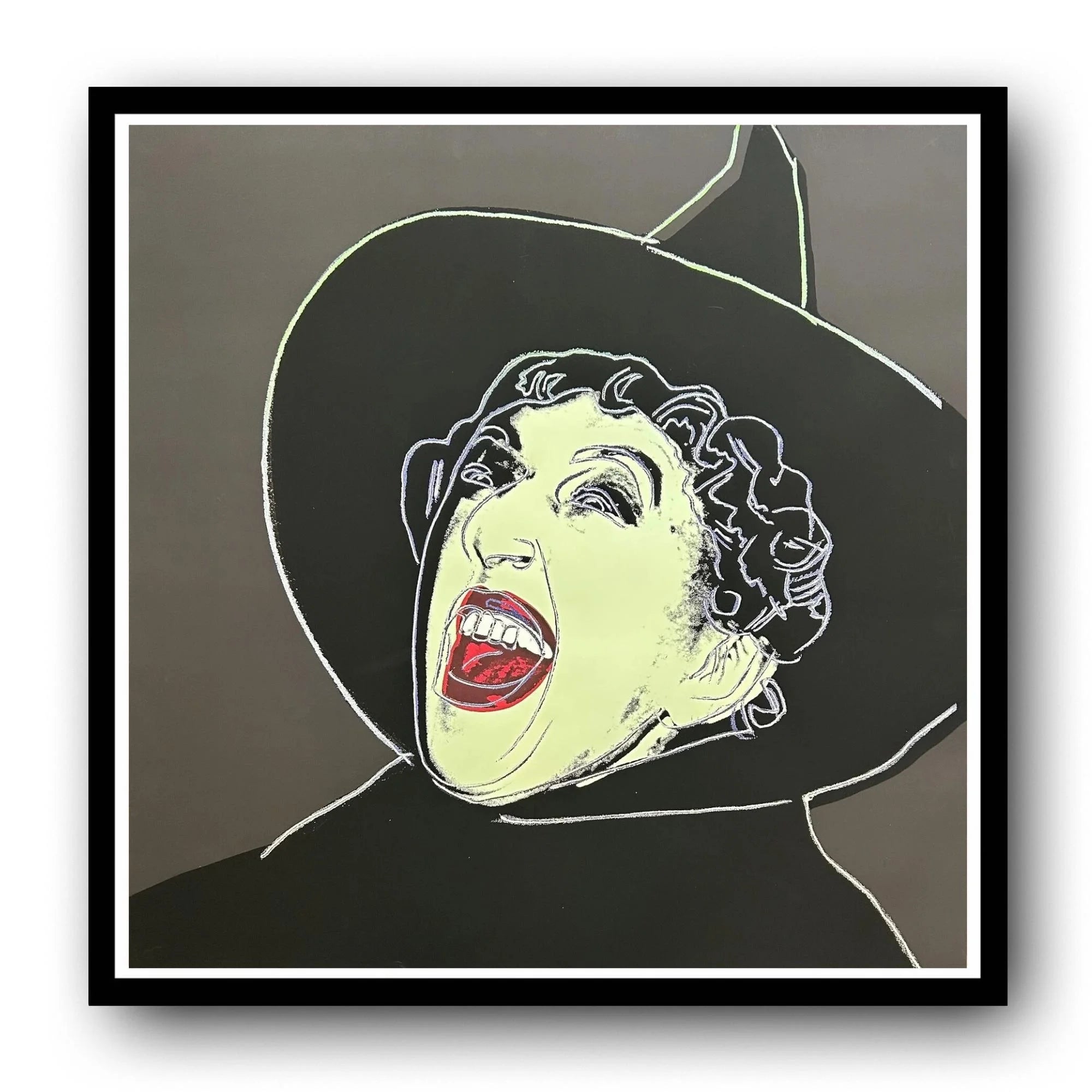 Framed artwork of a stylized Wicked Witch with a wide open mouth on a gray background